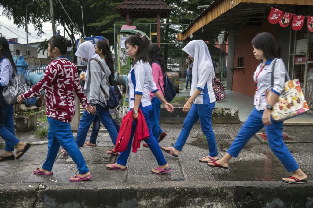 women walking on a sidewalk