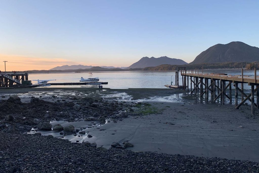 float planes at a dock at sunrise