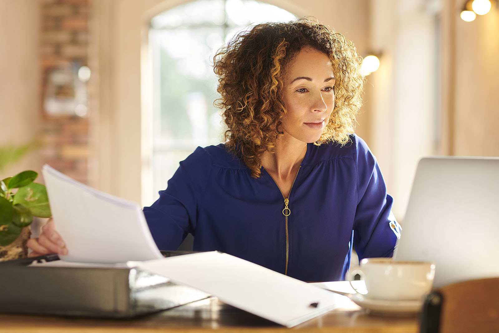 businesswoman working from cafe