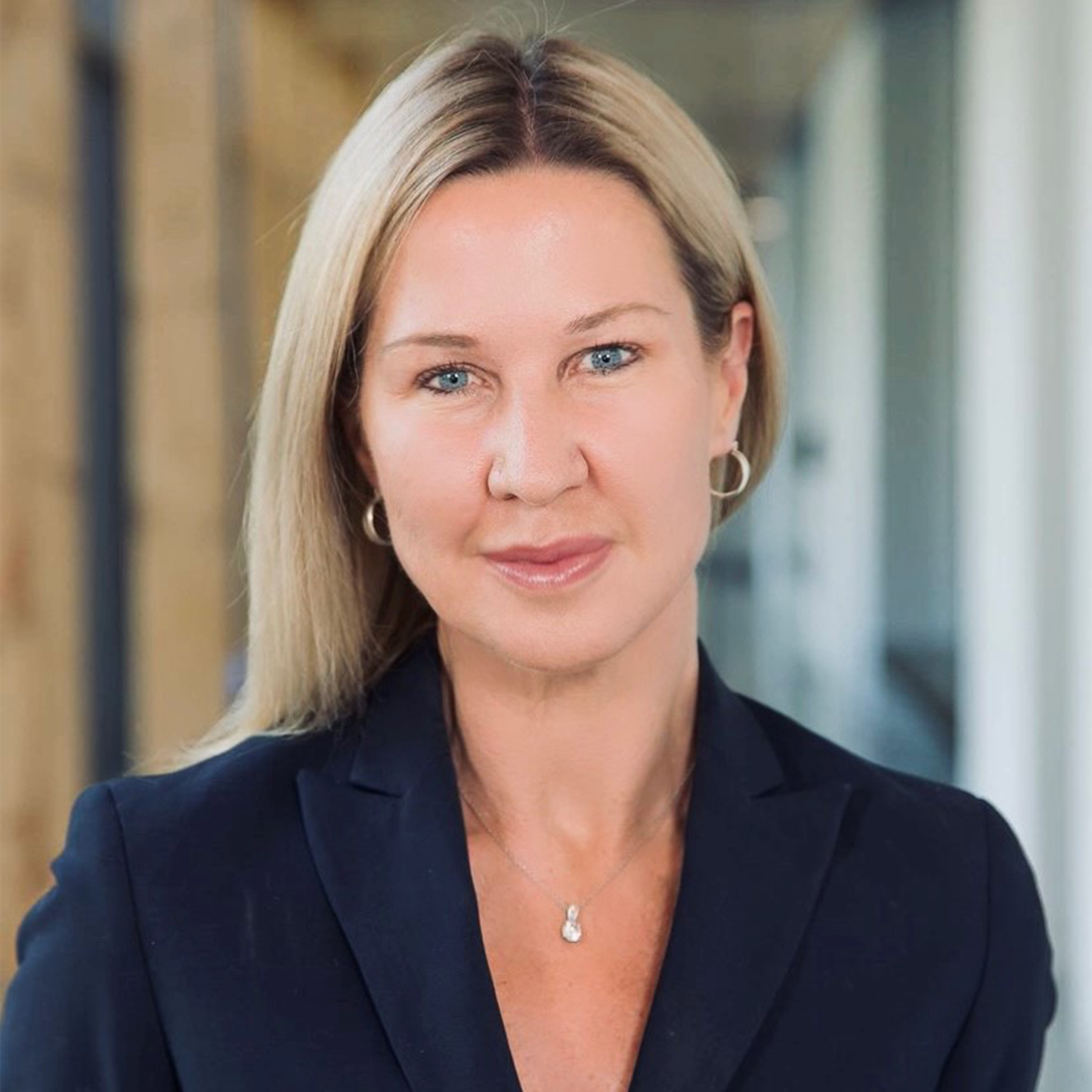 Headshot of Ann Fitz-Gerald wearing a dark blue blazer