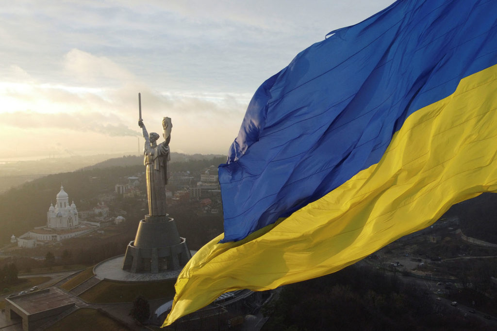 Ukraine's biggest national flag on the country's highest flagpole and the giant 'Motherland' monument are seen at a compound of the World War II museum in Kyiv, Ukraine, December 16, 2021. Picture taken with a drone.