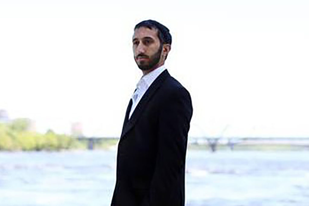 Deepan Budlakoti standing in front of a lake