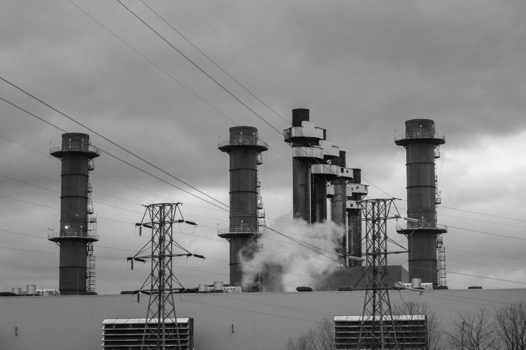 Photo of smoke stacks and electrical wires