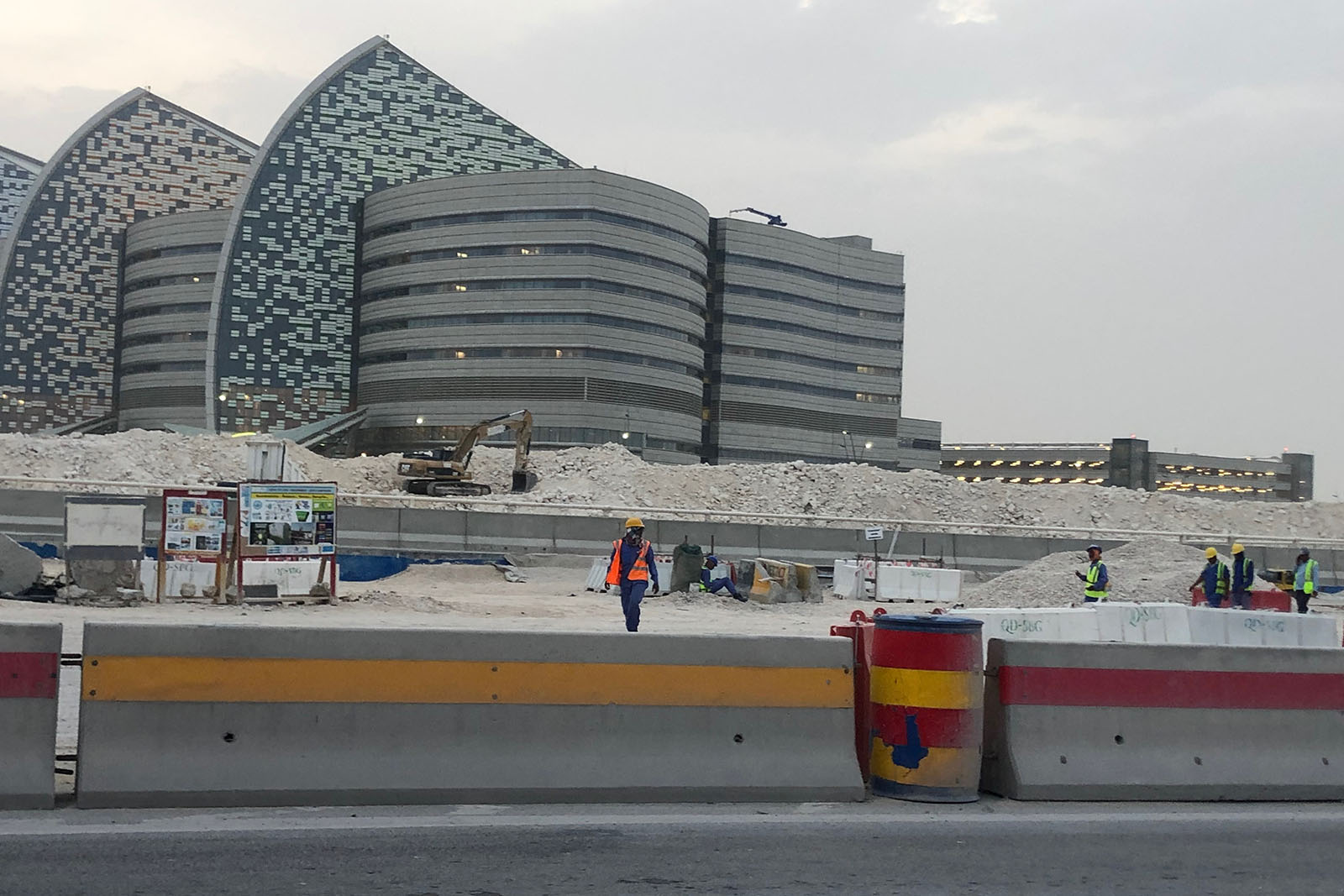 Migrant workers working outside a hospital in Qatar