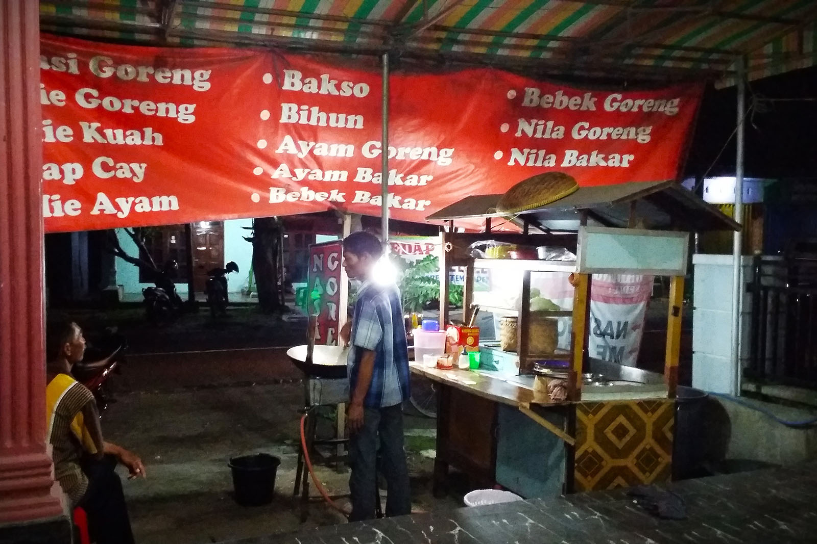 Two people standing by a food market