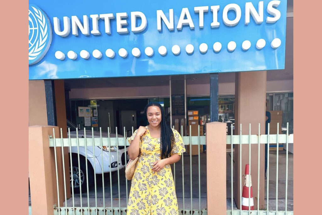 Chelsea Sidloski standing in front of a United Nations sign.