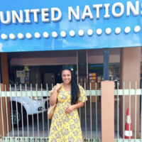 Chelsea Sidloski standing in front of a United Nations sign.