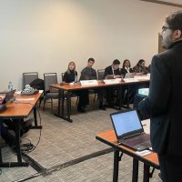 Adam Ladha addressing a room of students during the MNATO at Carleton University.